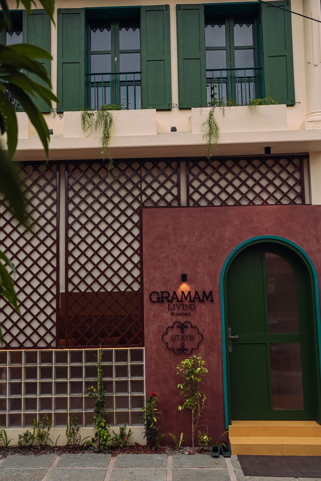 The villa's green timber door set in a patterned facade.